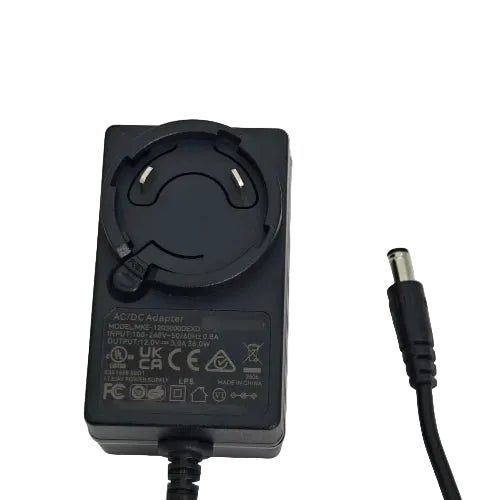 A black AC/DC power adapter with a circular plug and a black cable ending in a barrel connector, photographed on a plain light background.