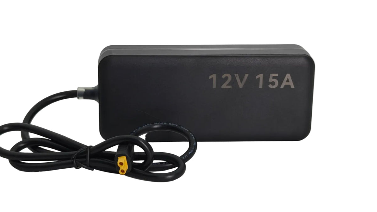A black rectangular 12V 15A power adapter with a coiled black cable and a yellow connector, shown on a light gray background.