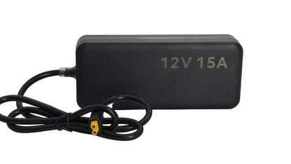 A black rectangular 12V 15A power adapter with a coiled black cable and a yellow connector, shown on a light gray background.